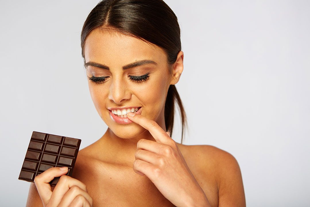 Sexy Woman Contemplating Chocolate Bar